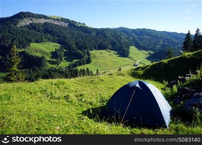 Tent on the slope of mount in Switzerland