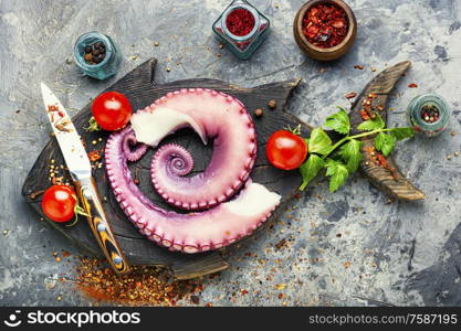 Tentacles of raw octopus on kitchen board.Food diet,healthy eating. Fresh raw octopus on cutting board