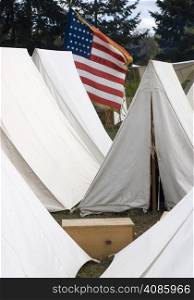 Tents and a flag in the military camp