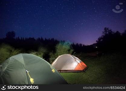 Tents in mountains under night sky. Tents in mountains under night sky with many stars
