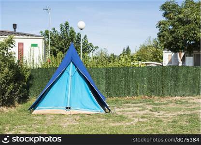 Tents on campsite. Green meadow
