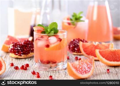 Tequila cocktail with pomegranate and grapefruit juice, tinted with the aroma of a fresh sprig of mint