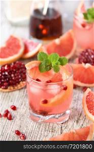 Tequila cocktail with pomegranate and grapefruit juice, tinted with the aroma of a fresh sprig of mint