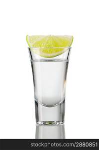 Tequila shot with lime isolated on white