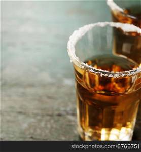 Tequila shots with salt on rustic background