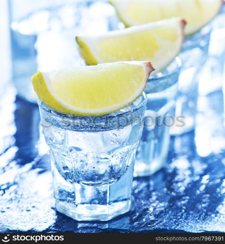 tequilla with limes on the black table