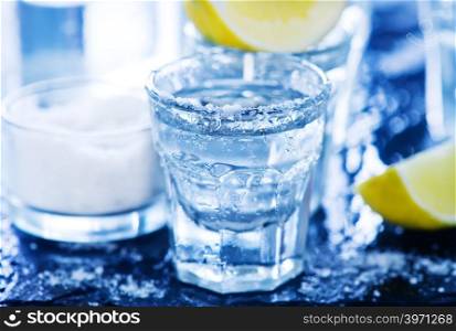 tequilla with salt and lime on a table