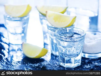 tequilla with salt and lime on a table