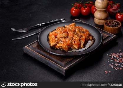Teriyaki chicken with sauce, sesame, herbs and spices on a dark concrete background. Asian cuisine. Teriyaki chicken with sauce, sesame, herbs and spices on a dark background