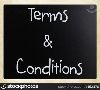 ""Terms & Conditions" handwritten with white chalk on a blackboard"