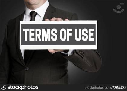 Terms of Use sign is held by businessman.. Terms of Use sign is held by businessman