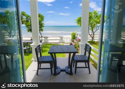 Terrace sea view with outdoor wood chairs and table