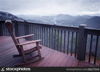 Terrace with chair, cup of coffee and mountain view