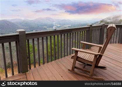 Terrace with chair, cup of coffee and sunrise mountain view
