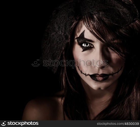 Terrifying witch portrait isolated on black background, attractive woman with scary makeup, Halloween party, horror concept