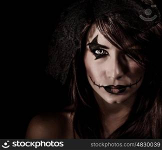 Terrifying witch portrait isolated on black background, attractive woman with scary makeup, Halloween party, horror concept