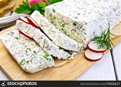 Terrine of curd and radish with dill, green onions on a paper and a board, knife, bread, parsley on a light wooden planks