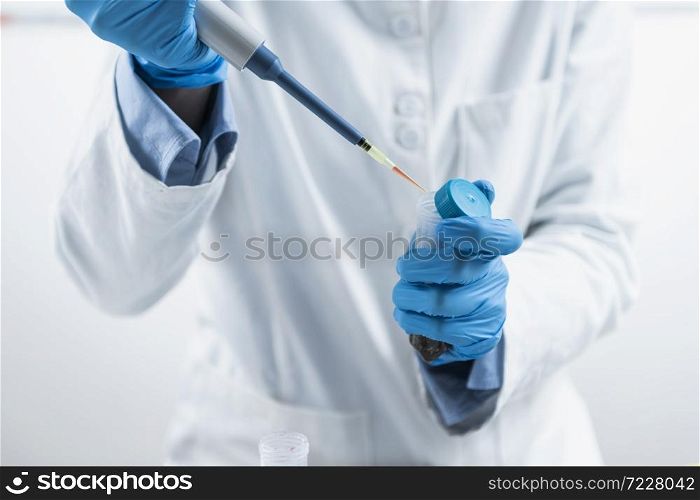 Test for Presence of Pesticides in Agricultural Products. Food Quality Inspector with Micropipette Adding Reagent into a Test Tube with Plant Sample