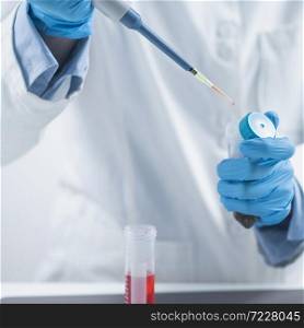 Test for Presence of Pesticides in Agricultural Products. Food Quality Inspector with Micropipette Adding Reagent into a Test Tube with Plant Sample