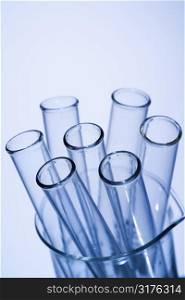 Test tubes in glass beaker with blue tint.