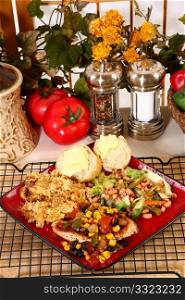 Tex Mex style chicken and yellow squash casserole with lettuce, black-eyed pea, and green bean salad.