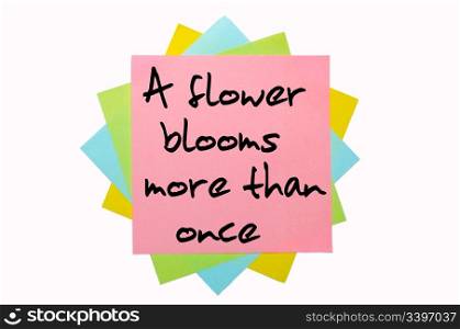 "text "A flower blooms more than once" written by hand font on bunch of colored sticky notes"