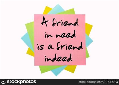 "text "A friend in need is a friend indeed" written by hand font on bunch of colored sticky notes"