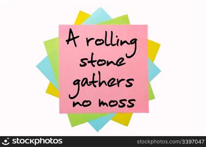 "text "A rolling stone gathers no moss" written by hand font on bunch of colored sticky notes"