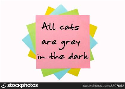 "text "All cats are grey in the dark" written by hand font on bunch of colored sticky notes"