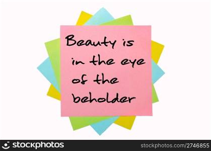 "text "Beauty is in the eye of the beholder" written by hand font on bunch of colored sticky notes"