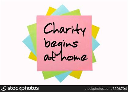 "text "Charity begins at home" written by hand font on bunch of colored sticky notes"