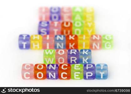 Text Concept on colorful cubes over white. Texts study, work, thinking and idea blurred on background