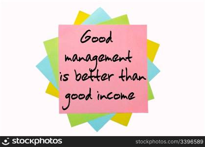 "text " Good management is better than good income " written by hand font on bunch of colored sticky notes"