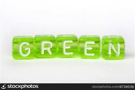 Text Green on colorful cubes over white