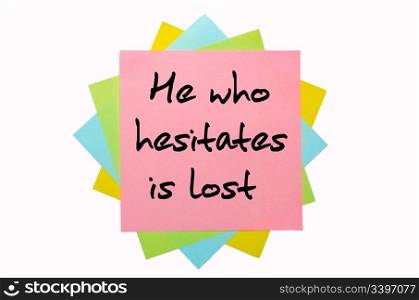 "text " He who hesitates is lost " written by hand font on bunch of colored sticky notes"