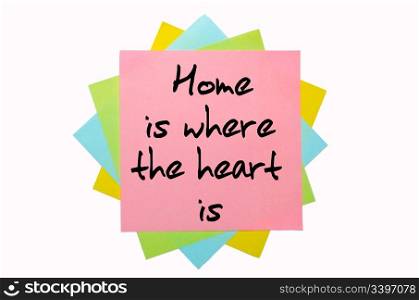 "text " Home is where the heart is " written by hand font on bunch of colored sticky notes"