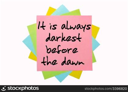 "text " It is always darkest before the dawn " written by hand font on bunch of colored sticky notes"