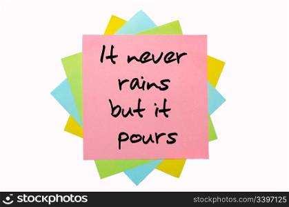"text " It never rains but it pours " written by hand font on bunch of colored sticky notes"