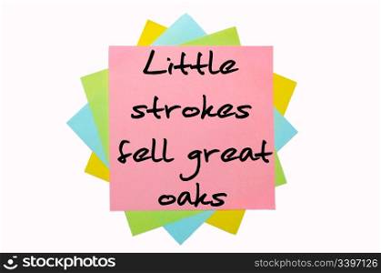 "text "Little strokes fell great oaks" written by hand font on bunch of colored sticky notes"