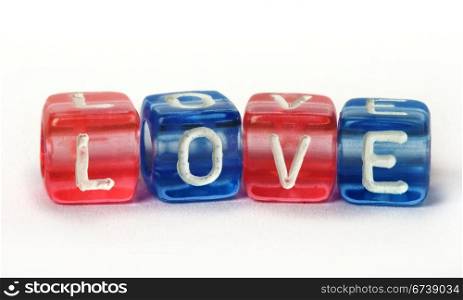Text Love on colorful cubes over white