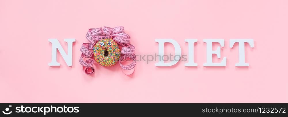 Text No diet and abstract funny face of woman from donut with eyes and hair from centimeter tape on plate on pink background. Concept International No Diet Day, 6 may Top view Flat lay Banner.. Text No diet and abstract funny face of woman from donut with eyes and hair from centimeter tape on plate on pink background. Concept International No Diet Day, 6 may Top view Flat lay Banner