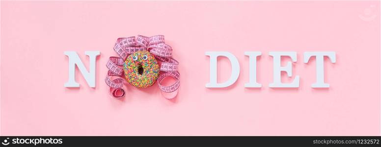 Text No diet and abstract funny face of woman from donut with eyes and hair from centimeter tape on plate on pink background. Concept International No Diet Day, 6 may Top view Flat lay Banner.. Text No diet and abstract funny face of woman from donut with eyes and hair from centimeter tape on plate on pink background. Concept International No Diet Day, 6 may Top view Flat lay Banner