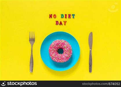 Text NO DIET DAY, pink donut on plate and cutlery table knife fork . Concept International No Diet Day, May 6.. Text NO DIET DAY, pink donut on plate and cutlery table knife fork . Concept International No Diet Day, May 6