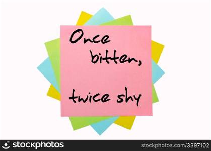 "text " Once bitten, twice shy " written by hand font on bunch of colored sticky notes"