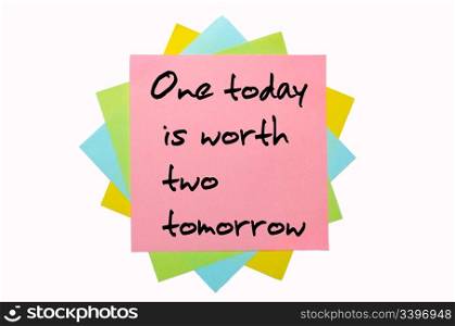 "text " One today is worth two tomorrow " written by hand font on bunch of colored sticky notes"