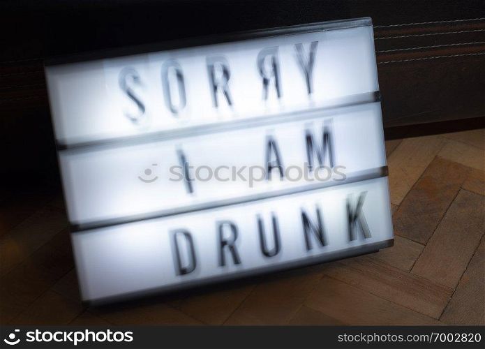 Text - Sorry I am drunk on white illuminated board. Concept for alcohol and drinking. Blurred text.