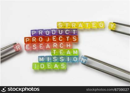 Text success, strategy,product,reserch,team and ideas on colorful wooden cubes over white