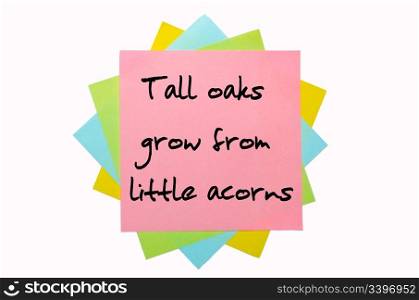 "text " Tall oaks grow from little acorns " written by hand font on bunch of colored sticky notes"