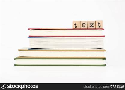 text word on wood stamps stack on books