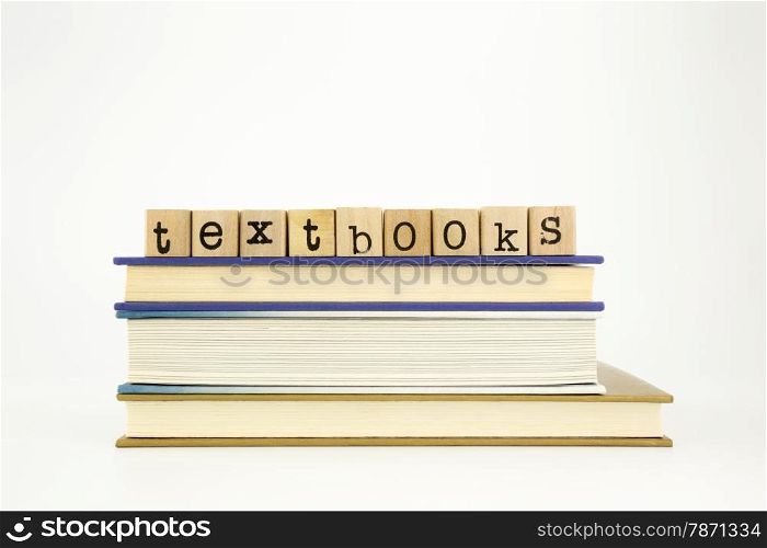 textbooks word on wood stamps stack on books, academic and study concept
